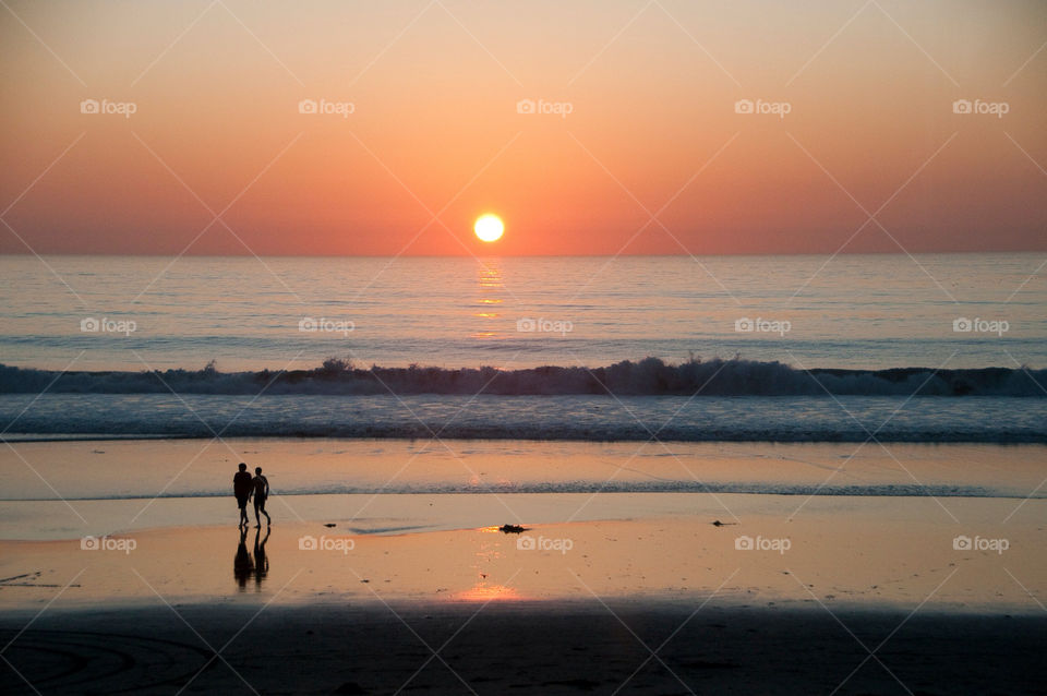 Playing on the beach at sunset sunny California