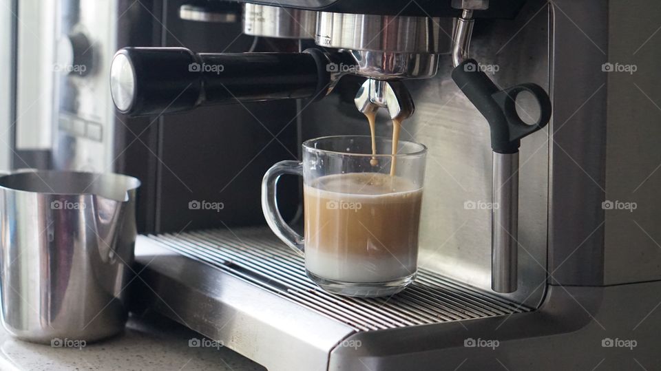 Preparing cup of espresso coffee