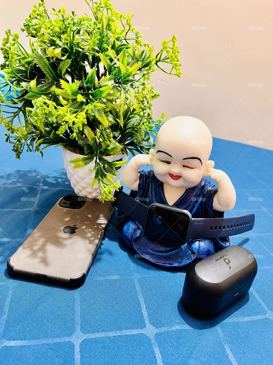 Buddha is spending time with electronics