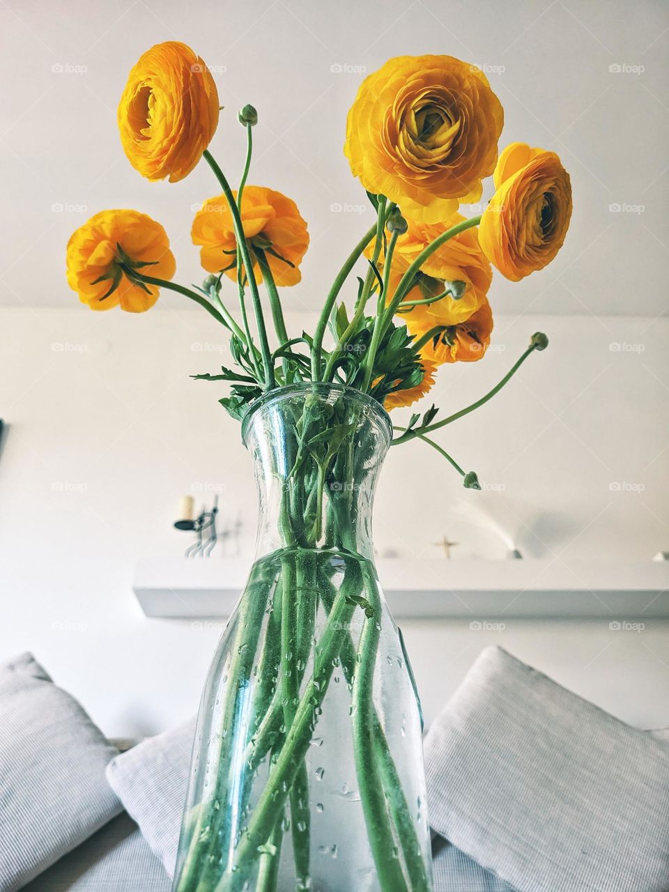 Top view of yellow blooming flowers in a vase at a cozy home. Ranunculus