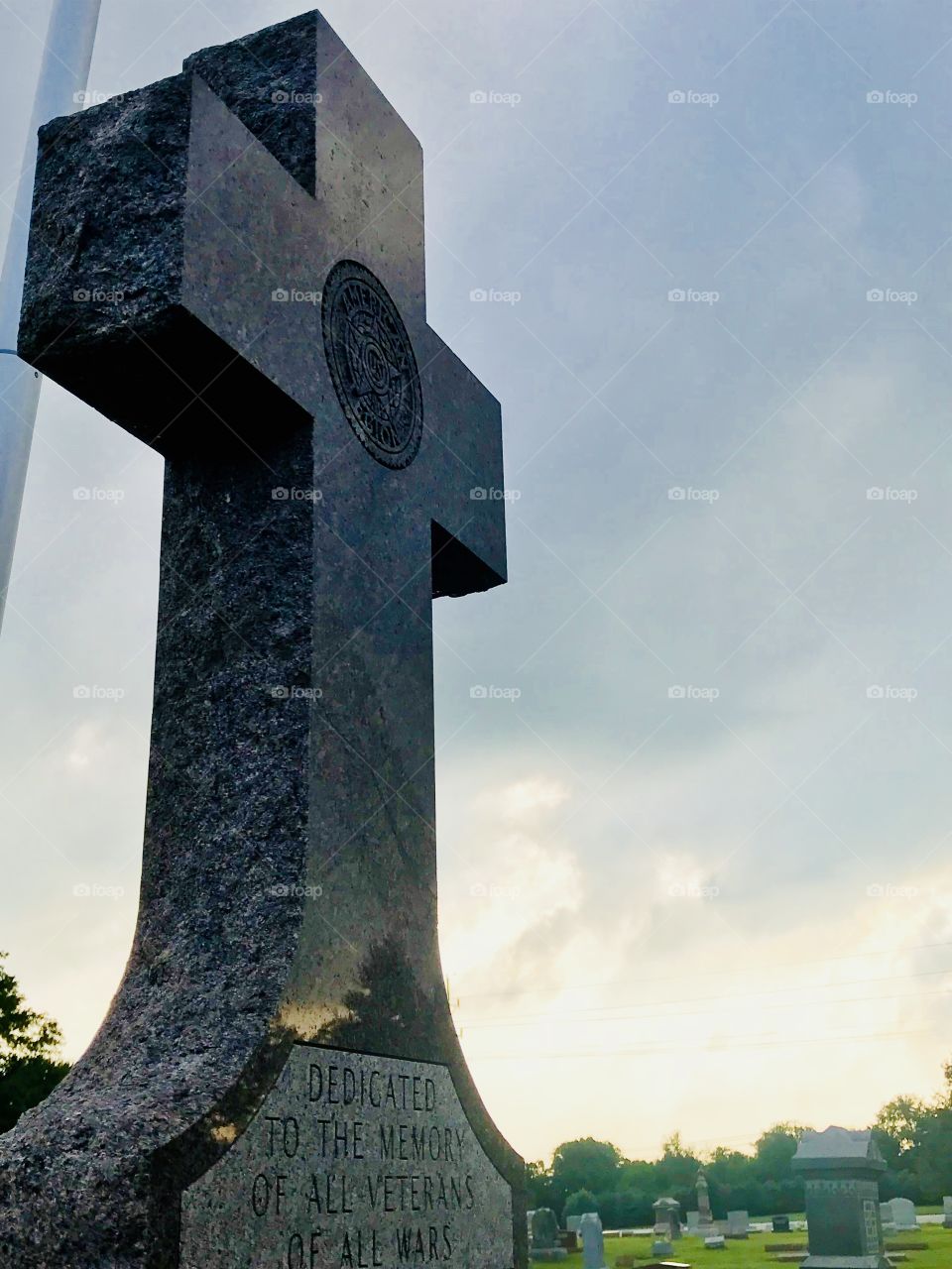 A monument in the middle of the graveyard dedicated to all those who have served. 