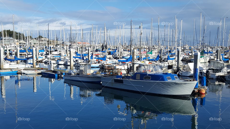 The sun managed to breakthrough over many sailing and fishing vessels docked in Monterey Bay.