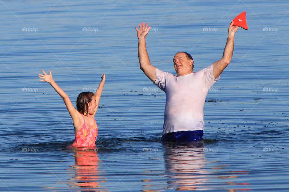 Summer fun includes playing with the bright floating frisbee on the shore and in the water. My husband & youngest daughter are letting out a little victory cheer because they won the match! ( Number of tosses before they miss) Nobody was counting!