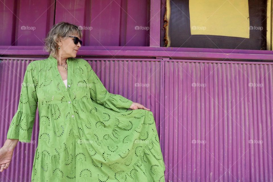 A mother and a grandmother with green dress and purple background 