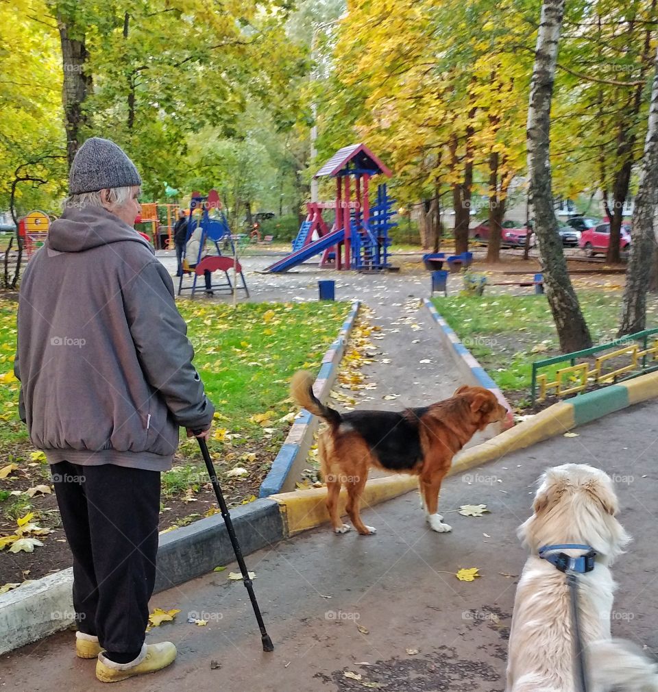 This man has a hard time waking. It looks like he took his dog out. 