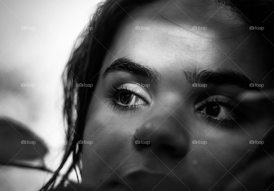 Portrait of a young woman in black & white with shadows on her face