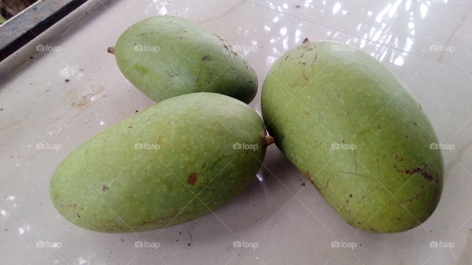 Three green mangoes