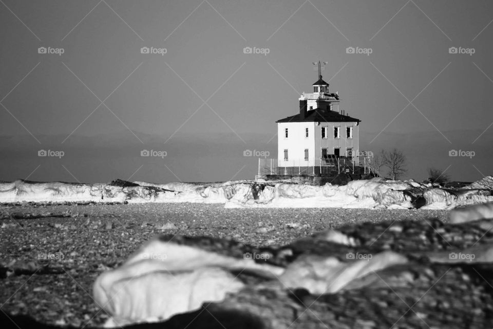 Lighthouse on Great Lakes in black and white in winter