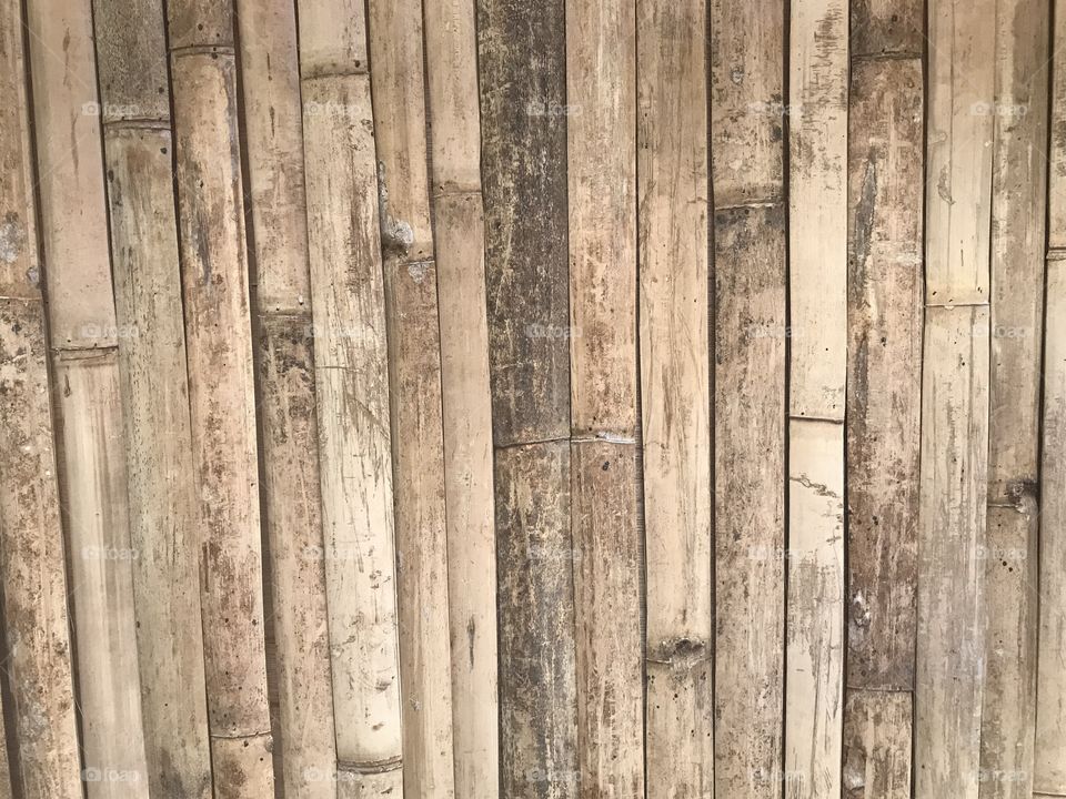 natural brown flat bamboo wood sheets attached together as a wall in full frame shot