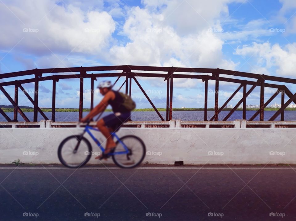 crossing the bridge with a bicycle