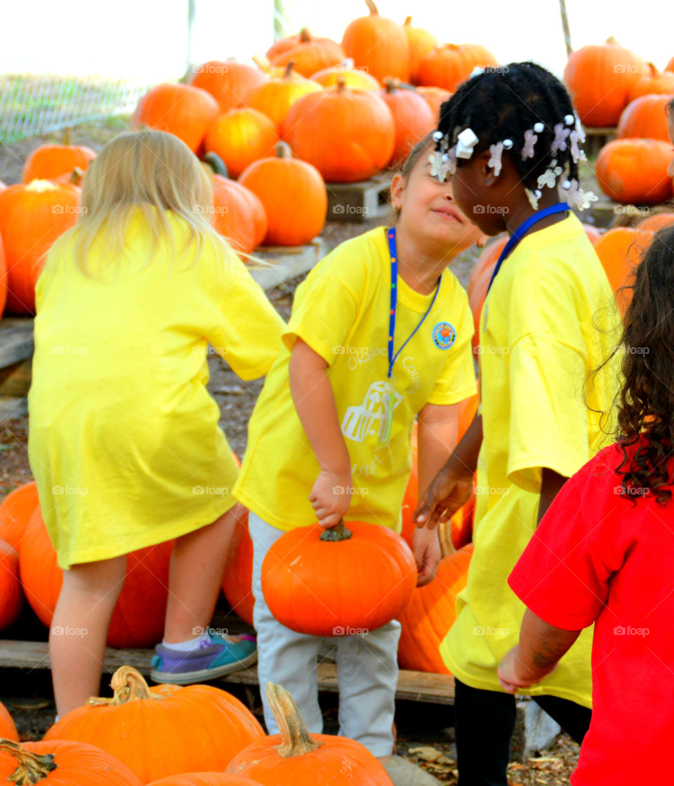 My pumpkin is bigger than your. Kids picking up pumpkins for their classmates and having fun!