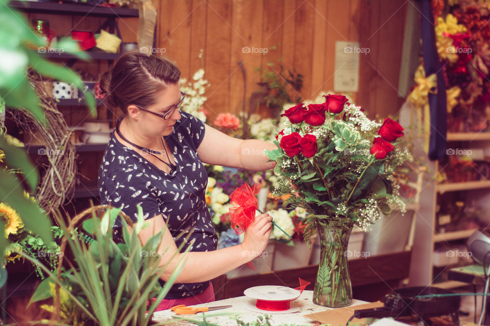 Woman Arranging Roses in a Vase at a Flower Shop 8