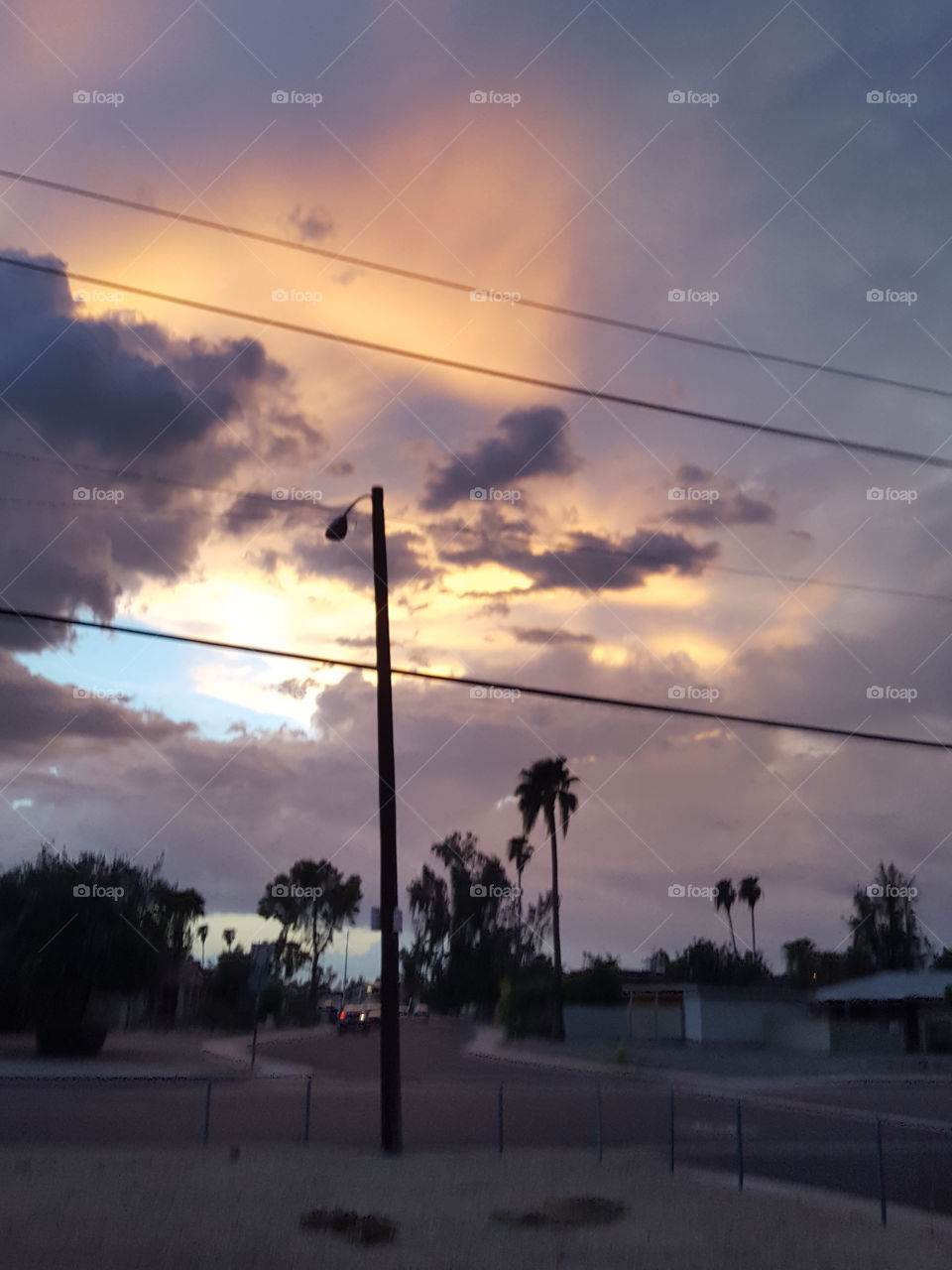 sunset rays peering through the storm clouds
