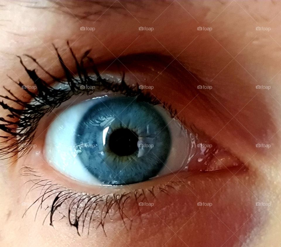 A blue eye with mascara