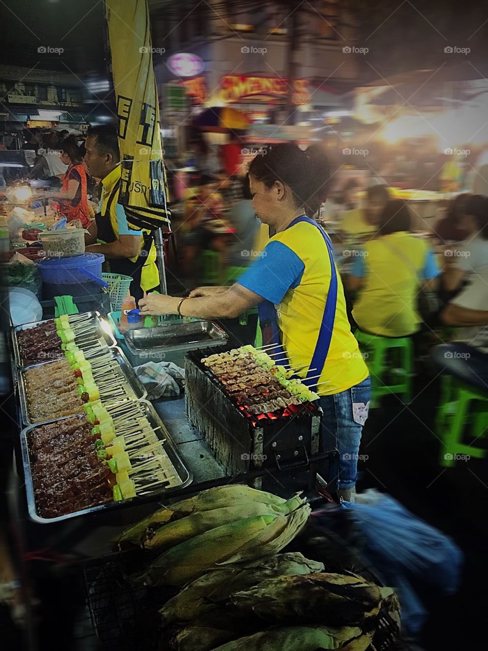 Woman preparing kebabs on barbecue grill