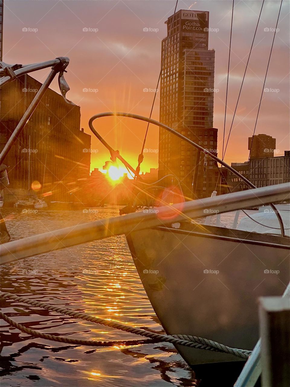 This fiercely glowing fireball is the sun setting over “Newtown Creek” by the “Pulaski Bridge” in LIC, Queens seen from “Salvation”, the “28 foot 1969 Luhrs” cabin cruiser that I and my partner “Timothy Trespas” call home. 2024. Hypnotic Productions