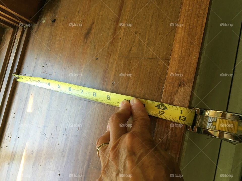 #stayathome - DIY Hands using tape measure on depth of window sill, getting ready for window replacement.