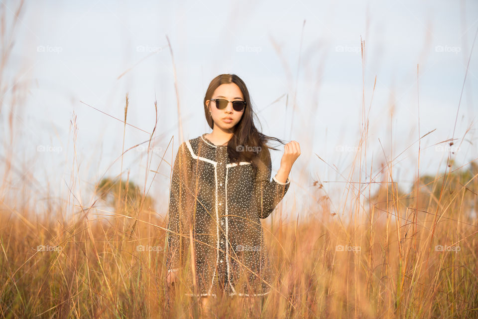 Asian girl in the field grass