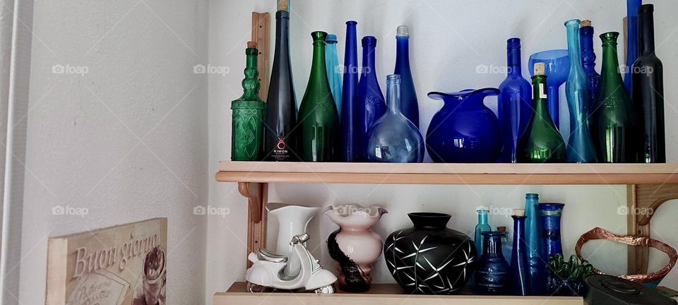 A collection of beautiful glassware and porcelain from bottles, vases, jars to bowls and eclectic artwork adorns the kitchen of the house in „Bavaria“, Germany that we have previously visited. 2023. Hypnotic Productions