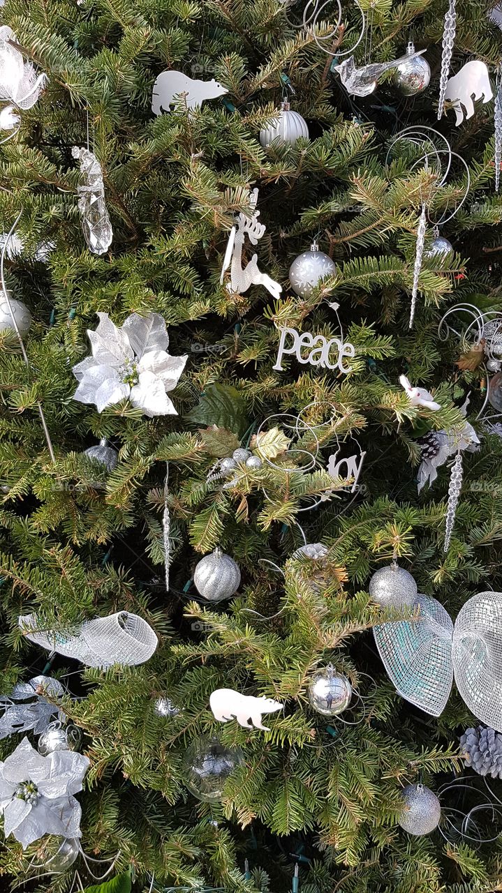 Christmas tree decorated with elegant silver ornaments, winter holidays festive background