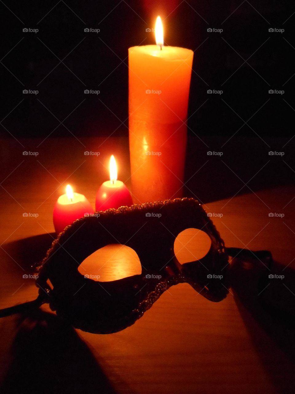 art abstract burning candles in the night and carnival mask