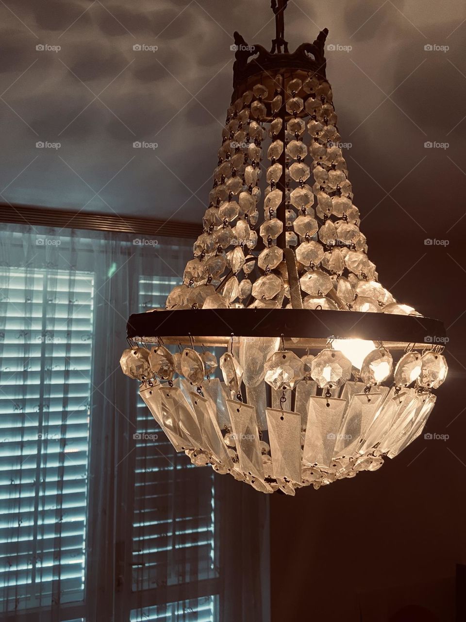 Vintage chandelier shining in a dark room.