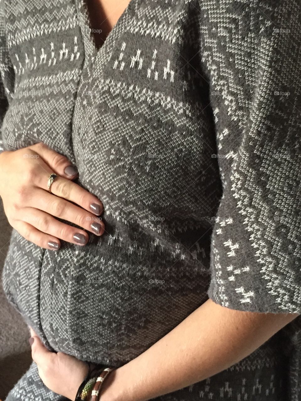 Hands on her tummy wondering is it time for baby!