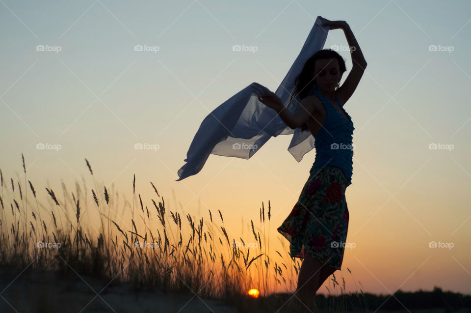 beautiful girl on the background of sunset