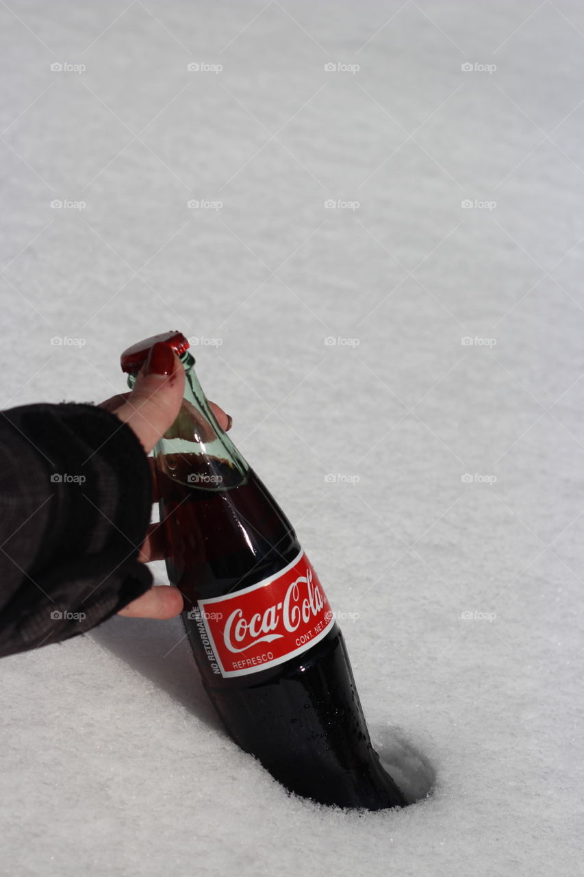 Woman Grabbing Coca Cola with white, smooth snow background