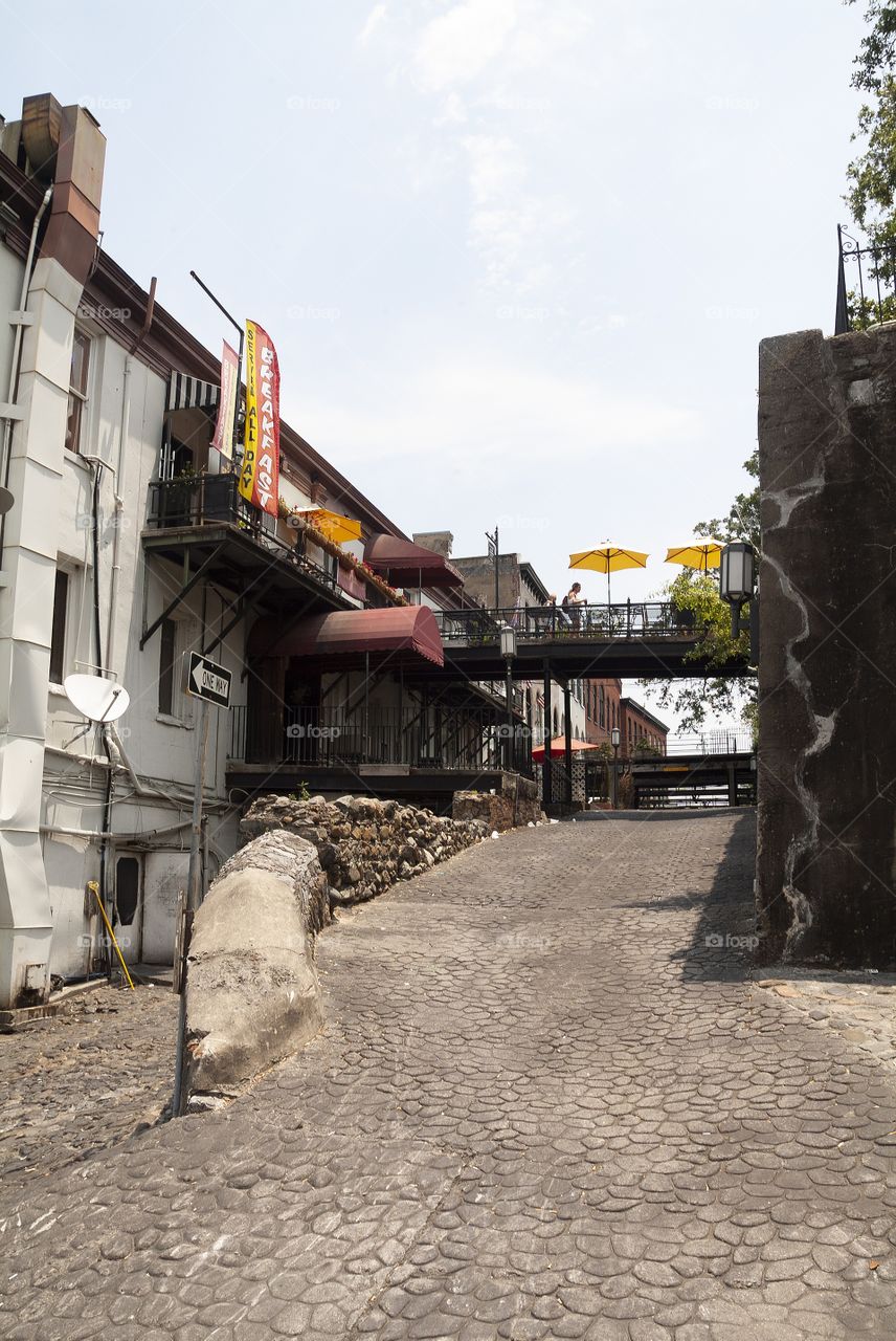 Old cobblestone streets can throughout all of historic downtown Savannah district of Georgia.
