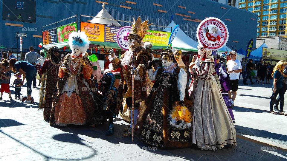 A group of street performers in colorful costumes