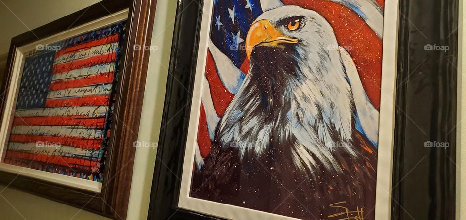 Two artists' works that depict symbols of American independence, freedom, unity, strength & resilience. Tim Yanke's American Flag with the words of The Star-Spangle Banner & Stephen Fishwick's Eagle with the American Flag.