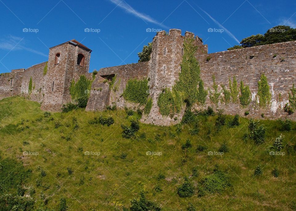 The incredible stone walls of the Dover Castle in England on a bright sunny summer day. 