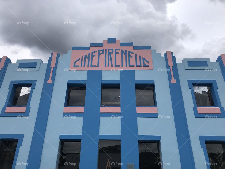 Facade cinema building painted in blue and pink