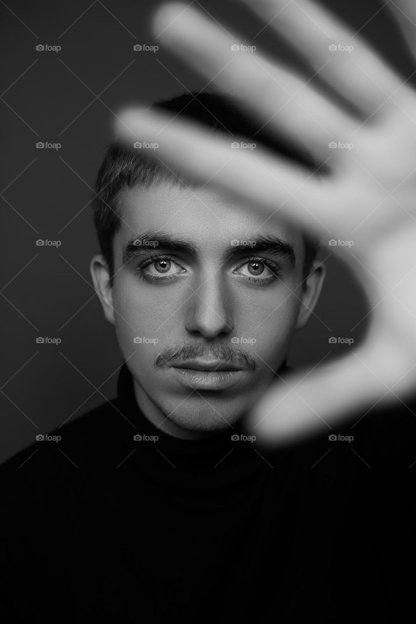 Portrait of young man in black and white colors .