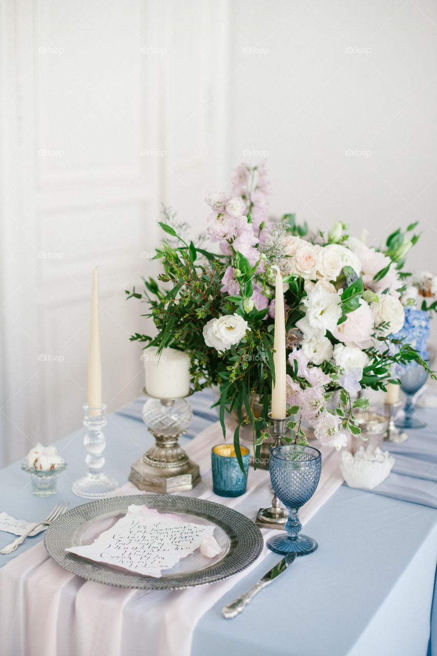 Silver candlestick and other elements of festive table wedding centerpieces decorations.