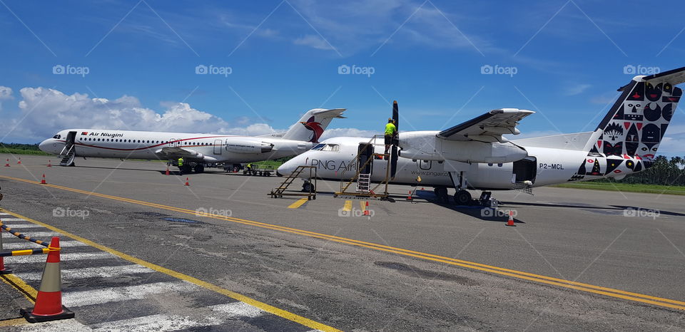 Fokker 100 and Dash 8 on tarmac at Tokua in East New Britain.