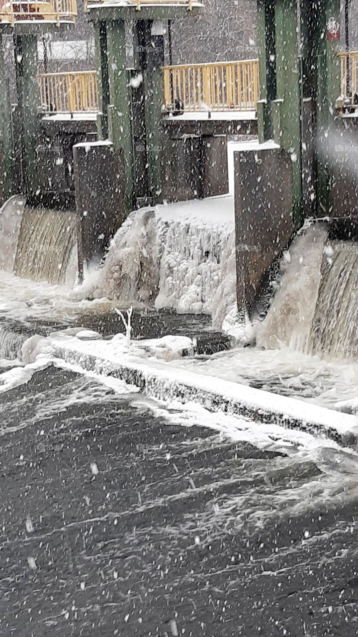 crazy ice mountains grow in the river - beautiful and dangerous, thick ice, frost and fresh snow on the river gate