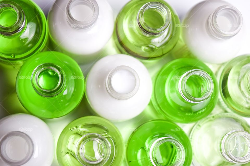 Small bottles filled with cream white and green.