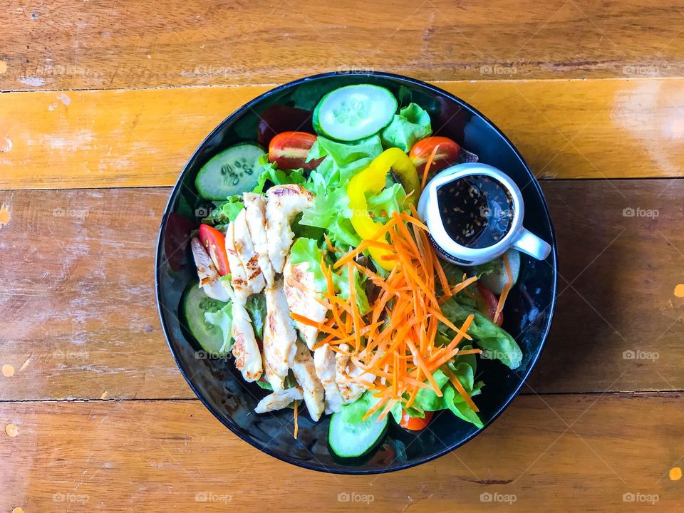 Chicken salad on wooden table. Healthy food. 