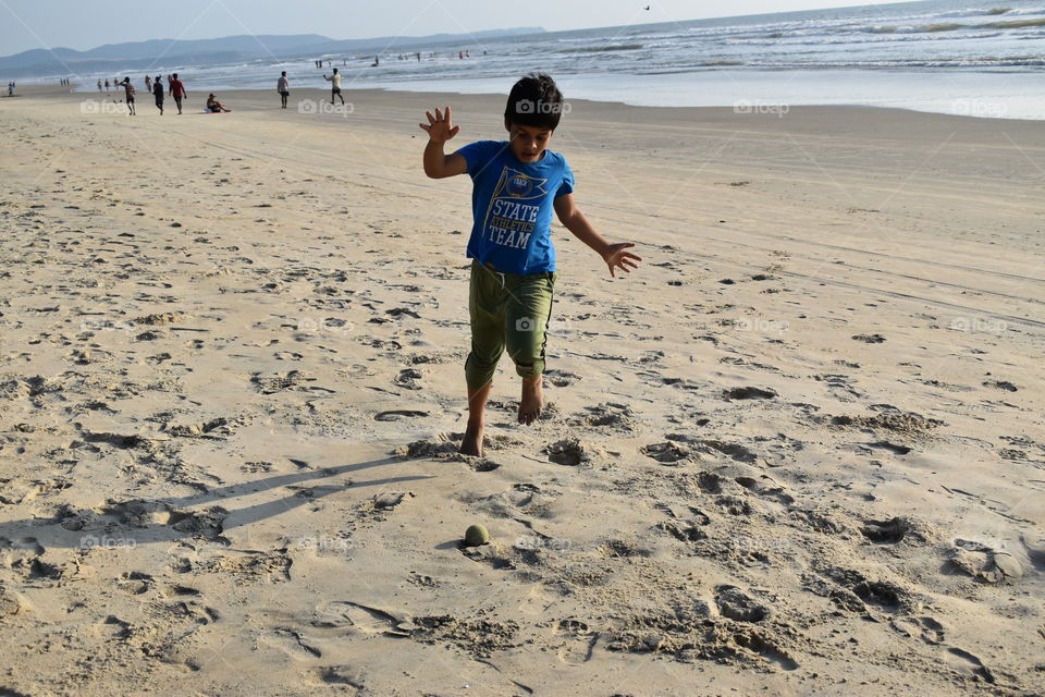 kid running and jumping on the beach