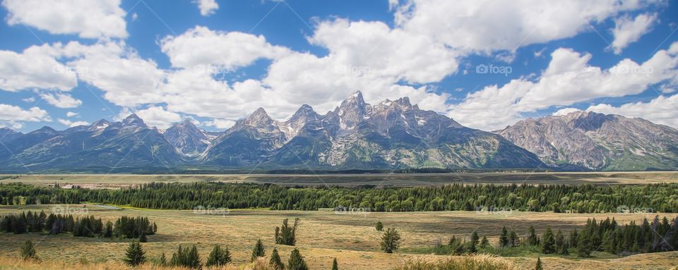 Scenic view of grand tetons against sky