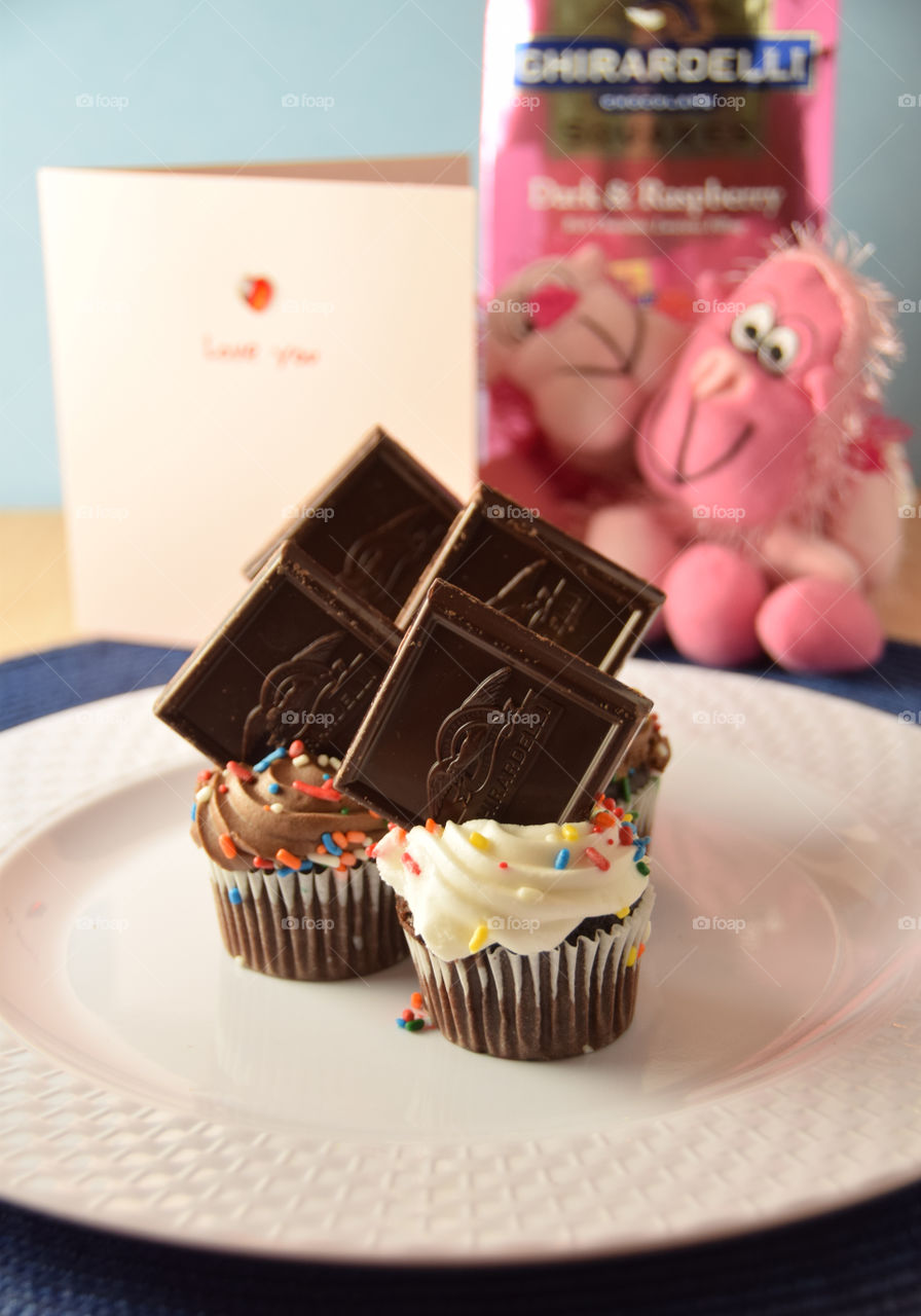 Gira deli chocolates on top of miniature cupcakes, plated for presentation