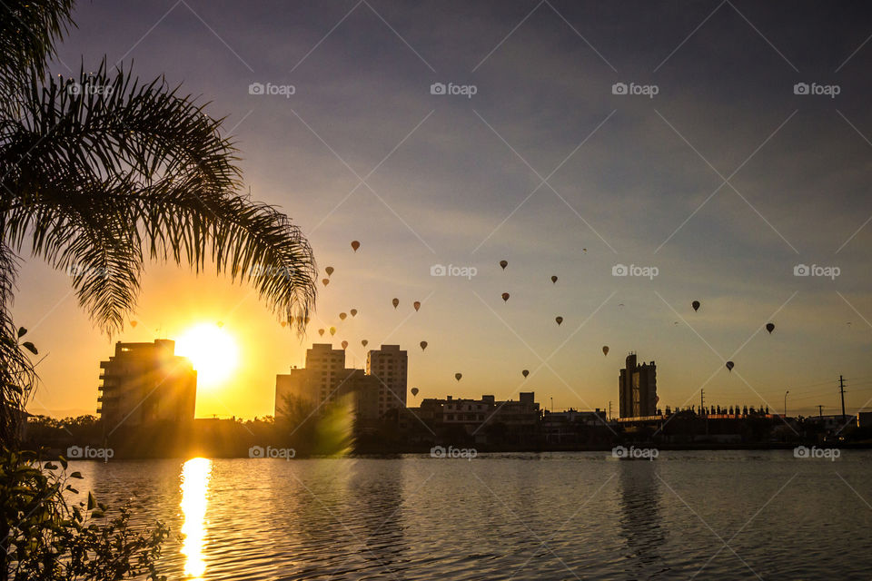 Balloons and sunset at city