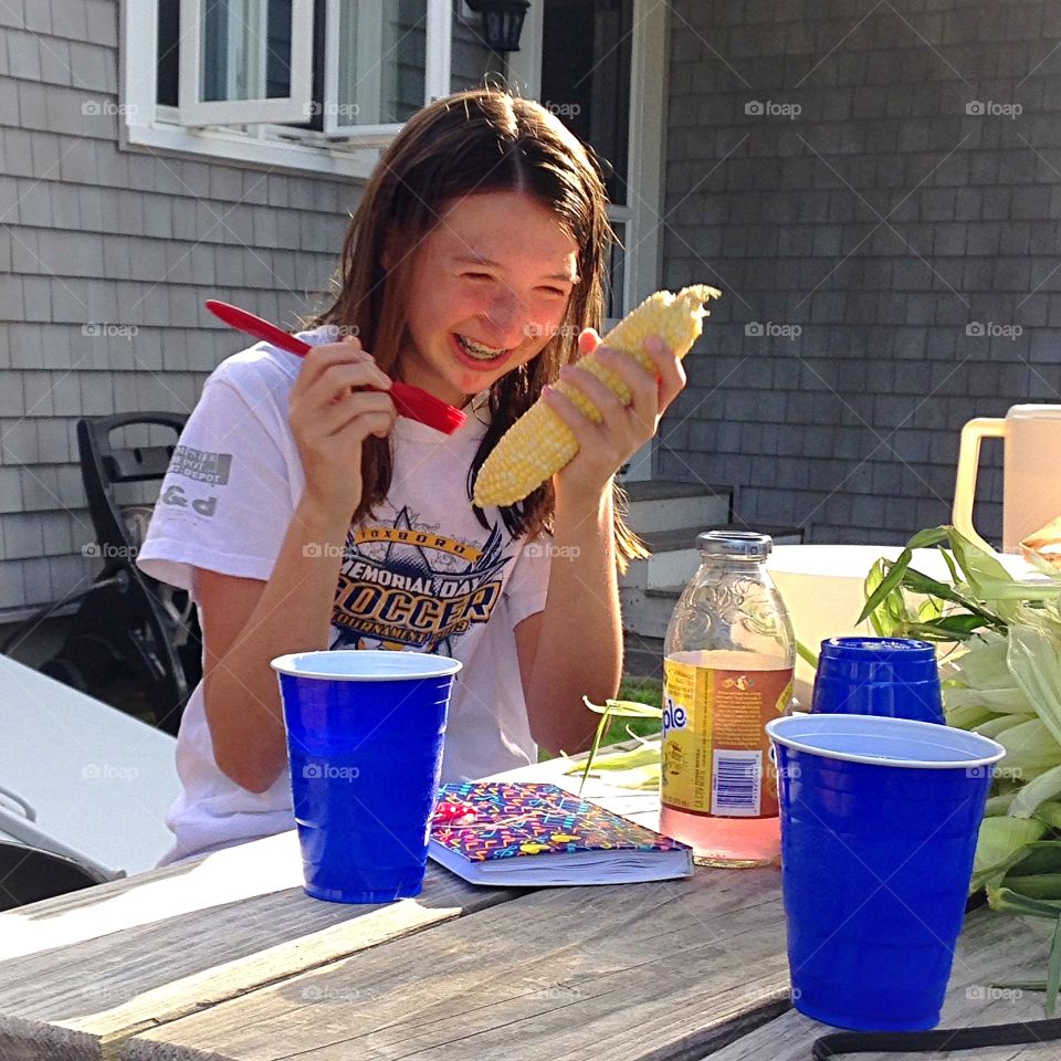 Shucking corn and having a lot of fun doing it! 
