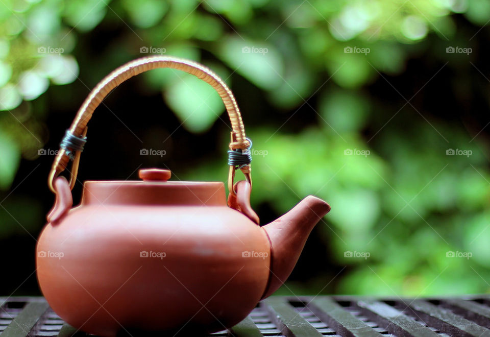 Old clay tea pot on table