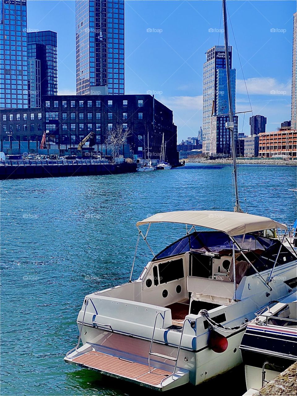 “Newtown Creek” by the “Pulaski Bridge” in LIC is central to many things transportation only being one.  The most gorgeous views are to be enjoyed here including idyllic boats from sailboats to motorboats to houseboats. 2023. Hypnotic Productions