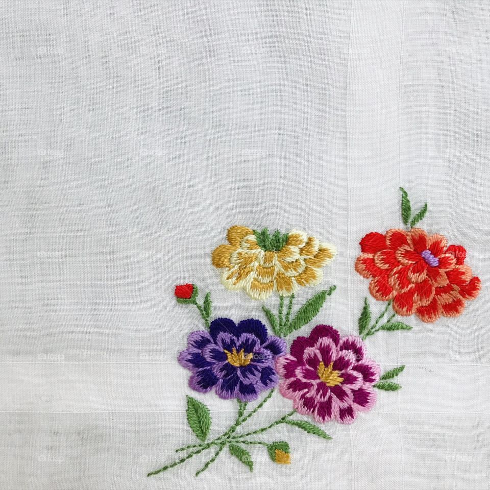 Bright vivid colorful flowers hand embroidery embroidered floral design with solid white background