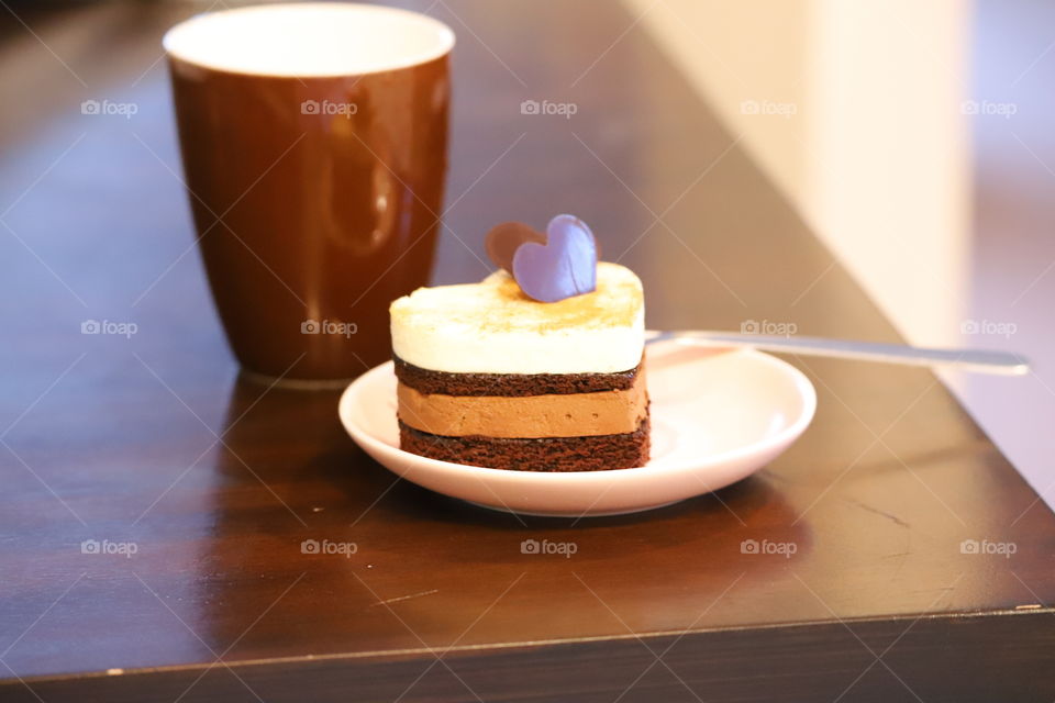 Heart shaped cake in a plate on the tabletop 