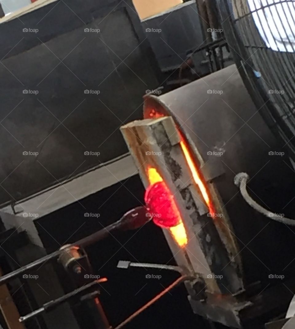 Glass blown pumpkin in kiln. Watching artisans create glass pumpkins